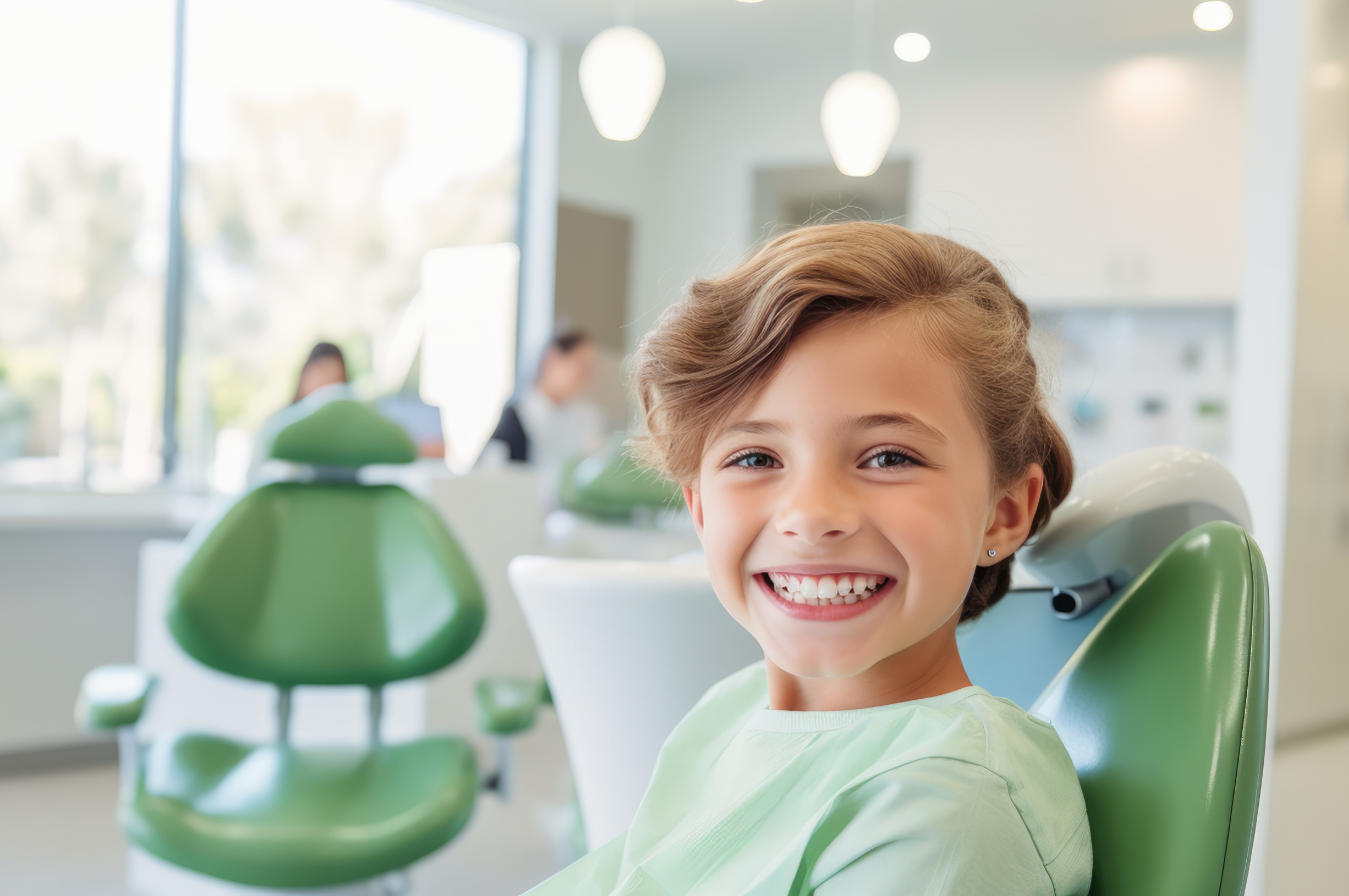 Smiling child in dental chair at pediatric dentist office, emphasizing importance of routine dental exams and children's dental health.