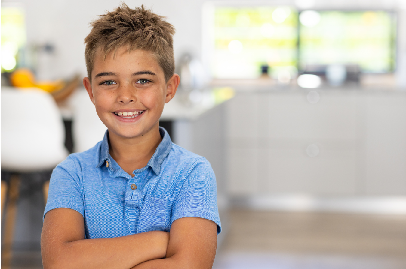 Smiling boy in a blue shirt, showcasing a healthy smile, representing pediatric dental health and the importance of dental care for children.